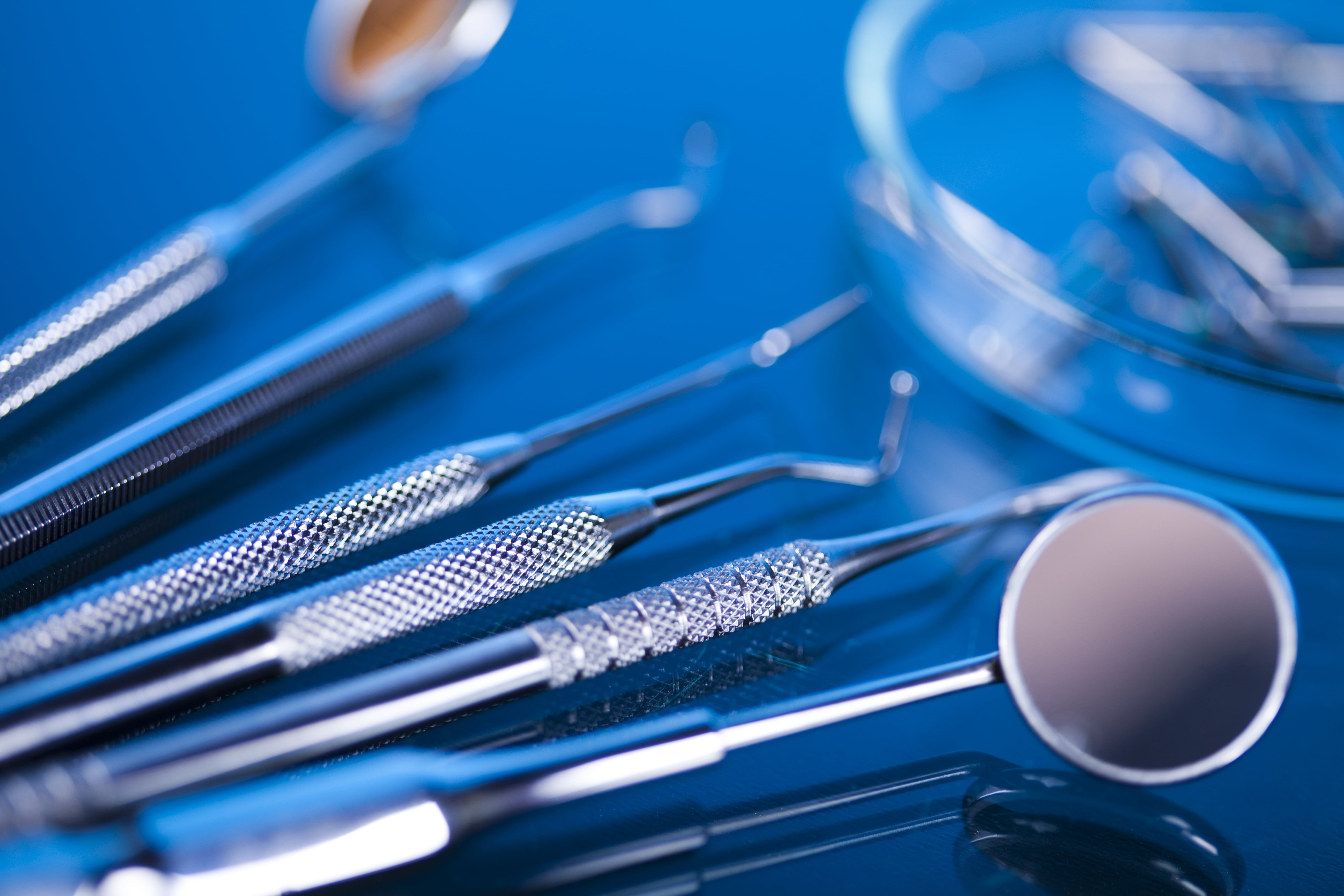 Various dental tools arranged against a blue background