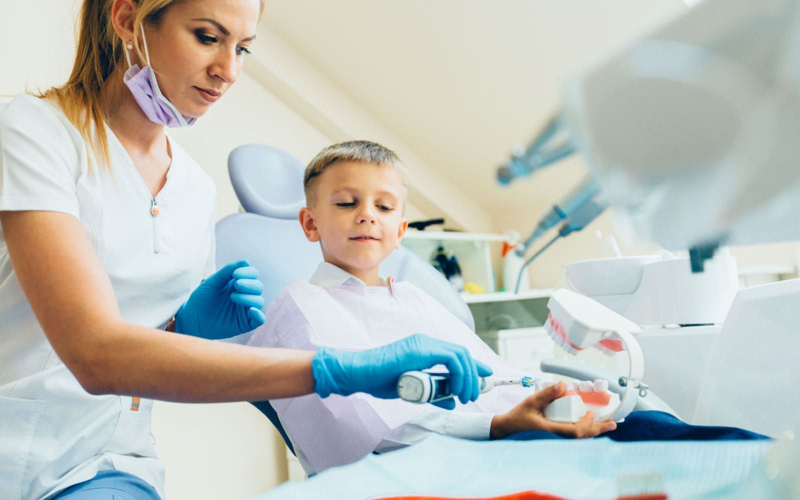 Child Recieving Dental Care from Dental Assistant