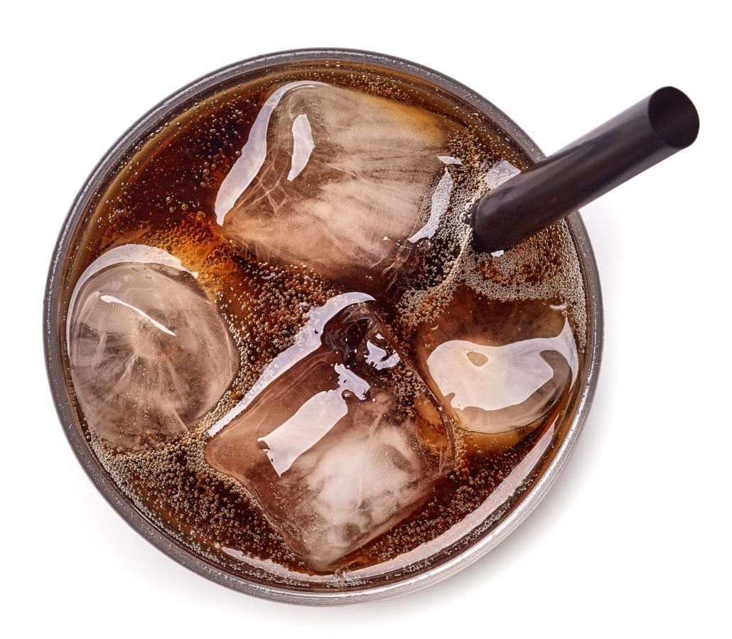 looking down on a soft drink with straw