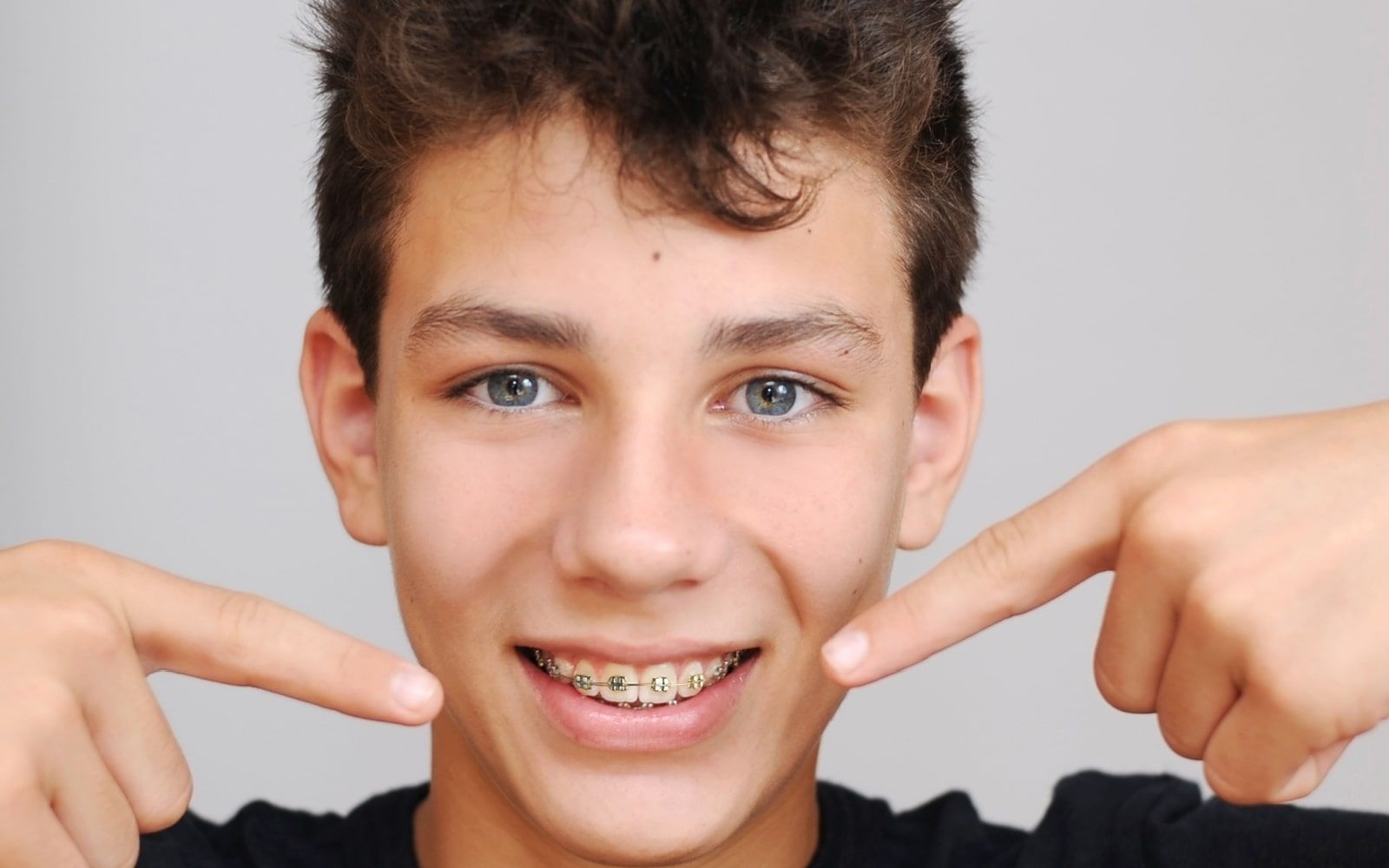 Teenager pointing at braces